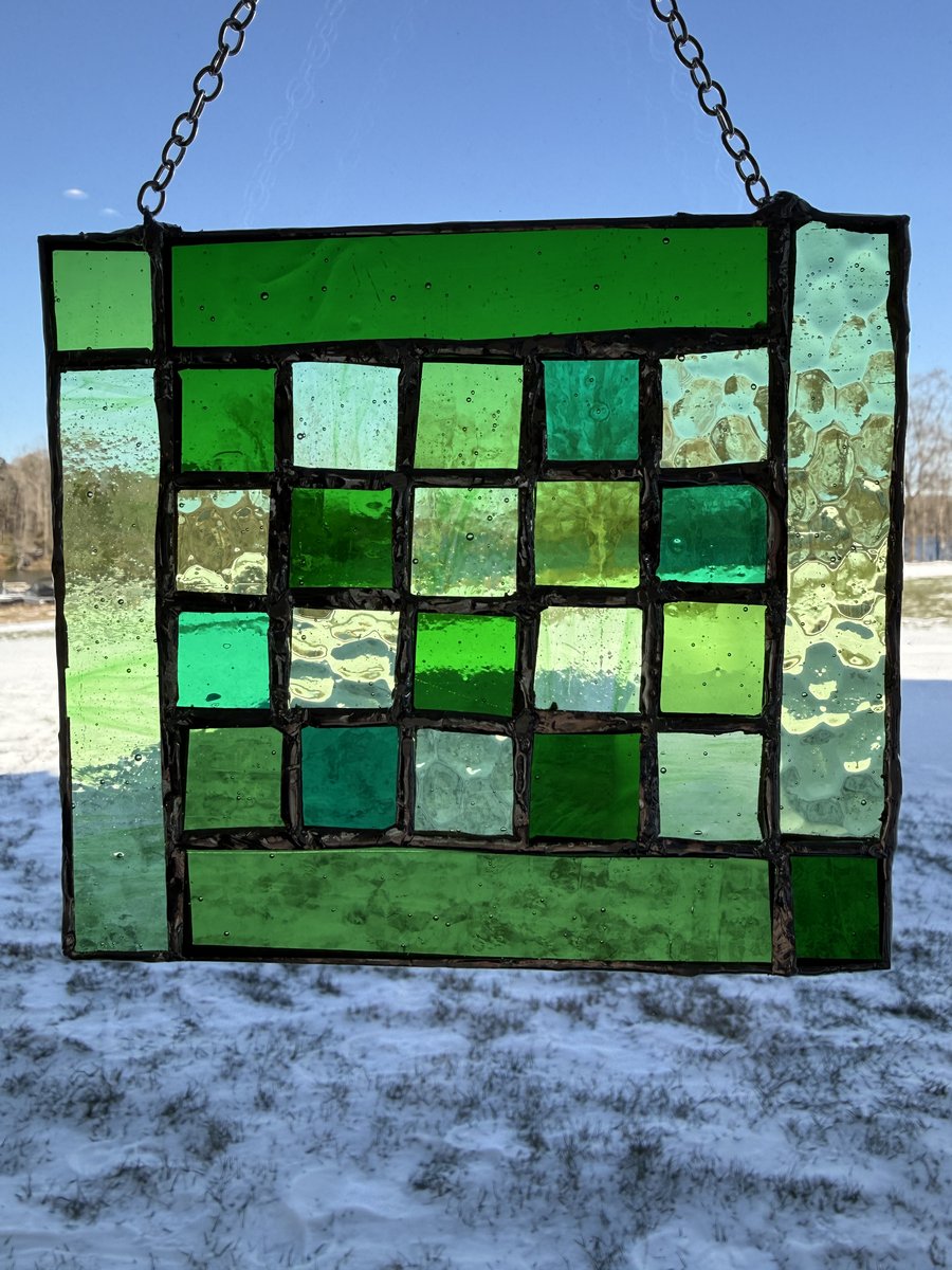 Green stained glass grid panel
