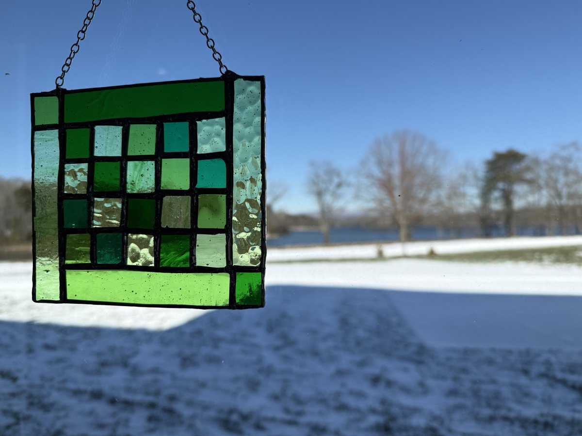 Small green glass panel with lake view